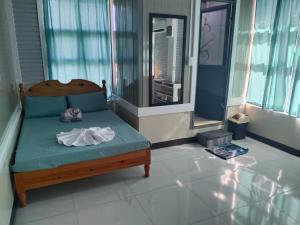 a bedroom with a bed in a room with windows at Ahava Lodge in Cervantes