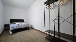 a bedroom with a bed and a book shelf at Optimus Japón in Coria del Río