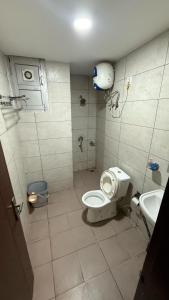 a bathroom with a toilet and a sink at Royal castle in Zirakpur