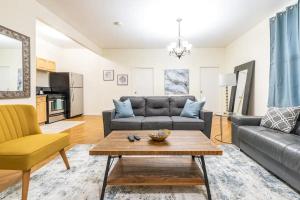 a living room with a couch and a table at Prime Location Upper Manhattan Furnished Apartment in New York