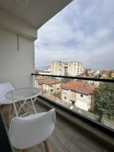 a balcony with a table and chairs and a view at Merlyn Apartment by Sienna in Skopje +21 photos