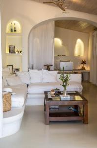 a living room with a white couch and a coffee table at COTTAGE BLUE in Pylos