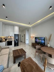 a living room with a couch and a table at Sea Breeze Polo Residence in Baku