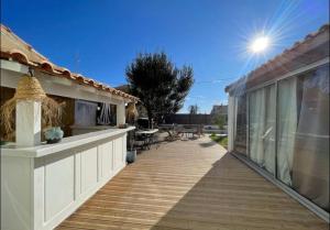 a balcony of a house with a wooden deck at Rêve Capestanais - B&B avec Piscine in Capestang