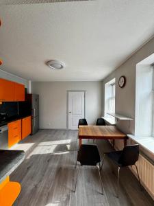 a living room with a wooden table and chairs at Bauska Old Town Apartments in Bauska +18 photos