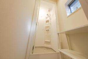 a small bathroom with a shower with a mirror at Make Your Hotel幡ヶ谷 in Tokyo +31 photos