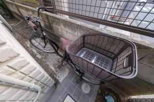 a shopping cart sitting next to a bike at Make Your Hotel幡ヶ谷 in Tokyo