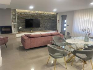 a living room with a couch and a table at Cantinho do Silvano in Gimonde