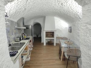 a kitchen with a sink and a counter top at Cueva El Rincón de la Calma in Guadix