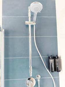 a shower with a shower head in a bathroom at Appartamento Fronte Mare con Ampio Terrazzo - Privitera in Villaggio Azzurro +26 photos