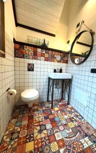 a bathroom with a toilet and a tile floor at Appartamento Porto Marina S G in Licata +38 photos