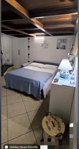 a bedroom with a bed and a table with a lamp at Holiday House Piccirillo in Vietri sul Mare