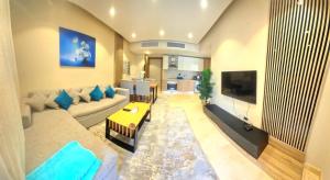 a large living room with a couch and a tv at Fabulous Sea view 1 BR & private Garden to the pool at Mangroovy in Hurghada