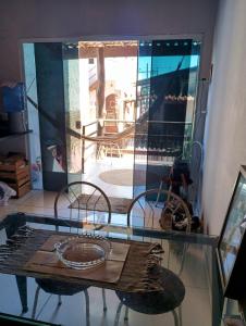 a glass table and chairs in a room at La Casa del Monica in Itacaré
