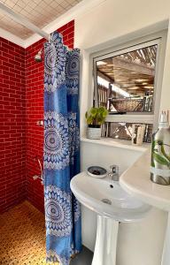 a bathroom with a sink and a shower at Casa Finchette rooftop apartment with panoramic views of Table Mountain in Cape Town