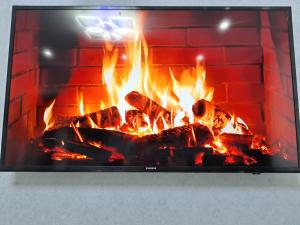 a fireplace filled with lots of fire at AirApartment in Chişinău +6 photos