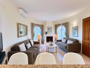 a living room with two couches and a fireplace at Beautiful Villa Close to Xabia & Moraira in Benitachell