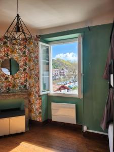 a room with a window and a green wall at Gite Compostella in Saint-Jean-Pied-de-Port