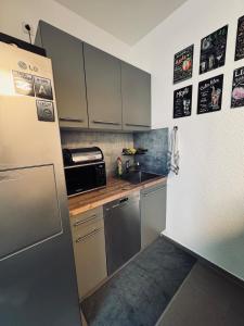 a kitchen with stainless steel appliances and a refrigerator at Ferienwohnung am Hoeschplatz in Düren - Eifel +19 photos