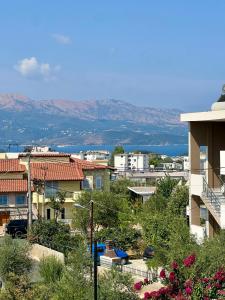 a view of a city with mountains in the background at Mihasi Apartments in Ksamil