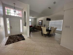 a dining room and living room with a table and chairs at Villa Vera with Lake view in Naples