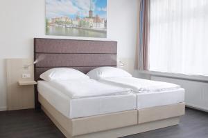Postel nebo postele na pokoji v ubytování Viva Hotel Lübeck