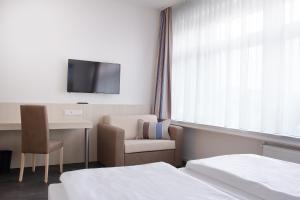 TV a/nebo společenská místnost v ubytování Viva Hotel Lübeck