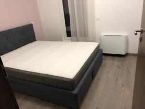 A bed or beds in a room at Ádám Guesthouse I.