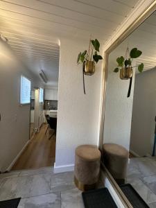 a living room with two stools and a mirror at Les terrasses de Valère in Sion +7 photos
