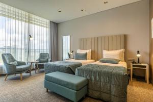 Postel nebo postele na pokoji v ubytování Montebelo Girassol Maputo Hotel