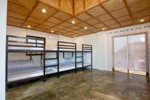 two bunk beds in a room with a large window at Vacanza Capanna Beach House Near Vigan in San Vincente