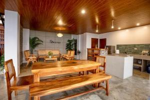 a living room with a wooden table and chairs at Vacanza Capanna Beach House Near Vigan in San Vincente