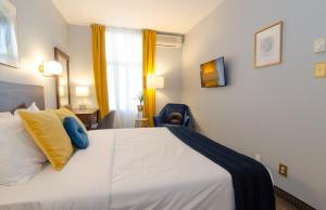Postel nebo postele na pokoji v ubytování Hotel Dorion
