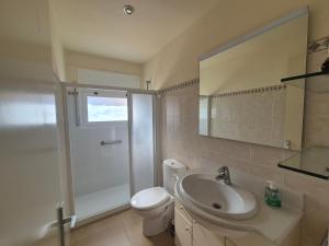 a bathroom with a toilet and a sink and a shower at Apartament Roqueta in Palamós +2 photos