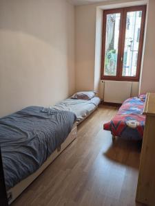 Ένα ή περισσότερα κρεβάτια σε δωμάτιο στο Appartement et salle de jeu