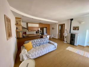 a living room with a couch and a kitchen at Casa Carmen Apartment Lake Como in Dongo