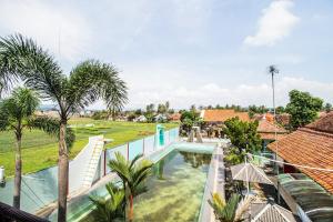 a view of the pool from the balcony of a villa at Hotel O Villa Tirta Melati Syariah in Banjar