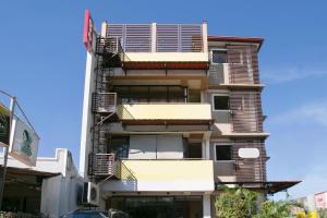 a tall building with balconies on the side of it at Rjat Guesthouse in Biñan +21 photos