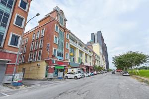 a city street with buildings and cars parked on the street at Hotel O Sohotel in Klang