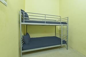 a bunk bed in a room with a blue pillow at Hotel O Sohotel in Klang