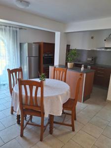 a kitchen with a table and some chairs and a table and a kitchen at Funtanella II in Patrimonio +15 photos