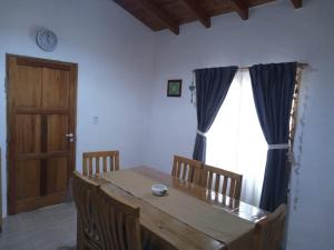 Un comedor con una mesa de madera y una ventana. en Nido Verde, en San Rafael 15 fotos más