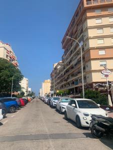 a row of cars parked on the side of a street at Global Sun - Casa Pasco in Playa de Gandia