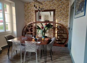 a dining room table with chairs and a mirror at Gite Compostella in Saint-Jean-Pied-de-Port