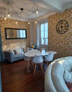 a living room with a white table and a couch at Gite Compostella in Saint-Jean-Pied-de-Port +27 photos