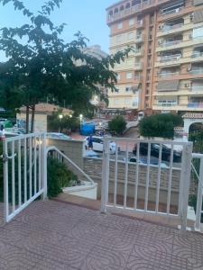 a white gate in front of a building at Global Sun - Casa Pasco in Playa de Gandia +45 photos