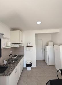 a kitchen with a sink and a refrigerator at Rincón del Chajá n°3 in Chajarí