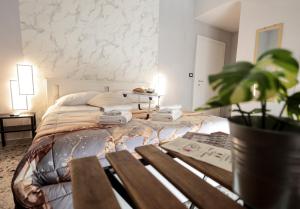 a bedroom with a bed with two alarm clocks on it at A cartulina e Napulè Attico con Vista Porto Ascensore Colazione Inclusa Struttura nel cuore autentico di Napoli a 5 minuti dalla Stazione Centrale e dal Centro Storico AC in Naples