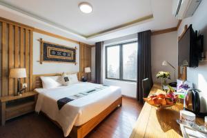 a hotel room with a large bed and a television at Sapa - Family Eco Home in Lao Cai
