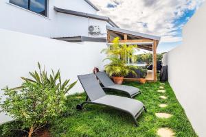 a patio with two chairs and a table at Sweet Moka in Sainte-Marie